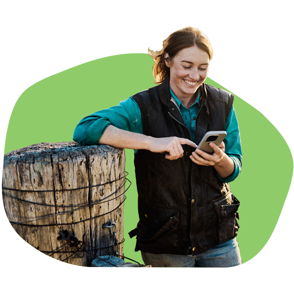 Smiling farmer looking at her phone