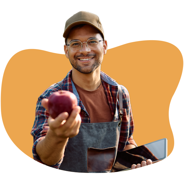 Smiling horticulturist holding an apple